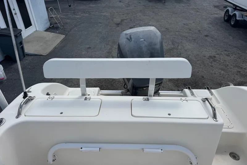 Slide: The Image of 1998 Legacy Boat 220 Sea Era with outboard motor and storage compartments. - 19