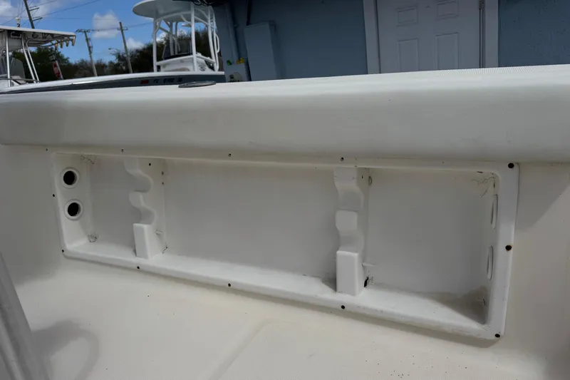 Slide: The Image of 1998 Legacy Boat 220 Sea Era interior compartment with rod holders and storage space. - 22