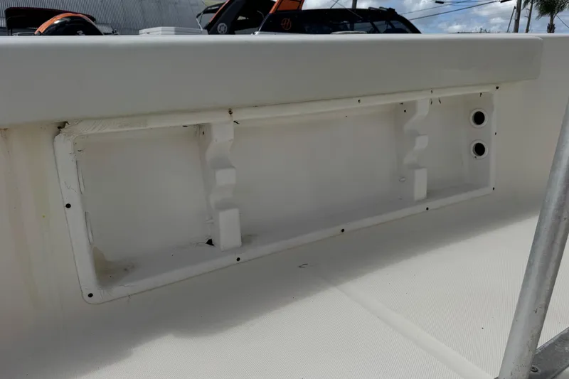 Slide: The Image of 1998 Legacy Boat 220 Sea Era interior detail, featuring a white compartment with mounting holes. - 23