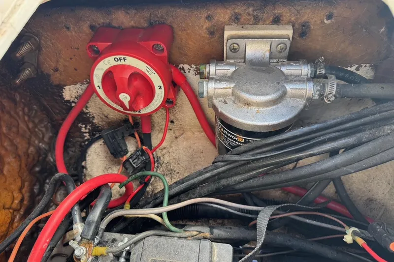 Slide: The Image of Electrical components and wiring inside a 1998 Legacy Boat 220 Sea Era. - 27