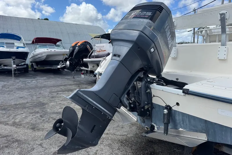 Slide: The Image of 1998 Legacy Boat 220 Sea Era with Yamaha V225 outboard motor in a marina setting. - 28