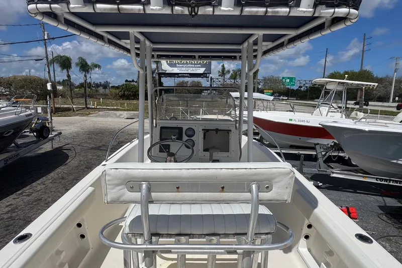 Slide: The Image of 1998 Legacy Boat 220 Sea Era with center console and T-top in a sunny marina. - 5