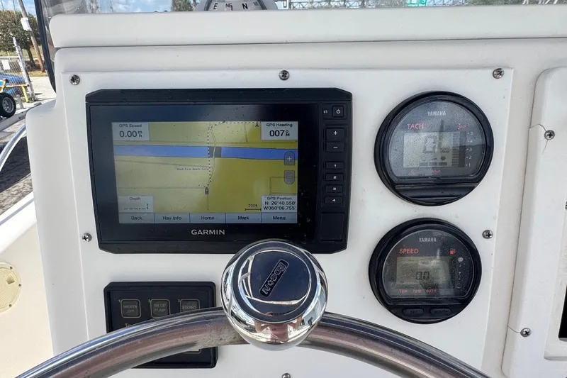 Slide: The Image of 1998 Legacy Boat 220 Sea Era dashboard with Garmin GPS and Yamaha gauges. - 7