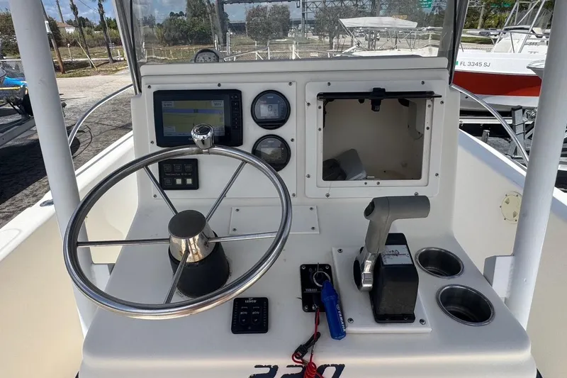 Slide: The Image of 1998 Legacy Boat 220 Sea Era dashboard with steering wheel and control panel. - 8