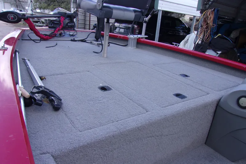 Slide: The Image of 2012 Tracker Pro Team 175 TXW fishing boat deck with carpeted surface and seating. - 10