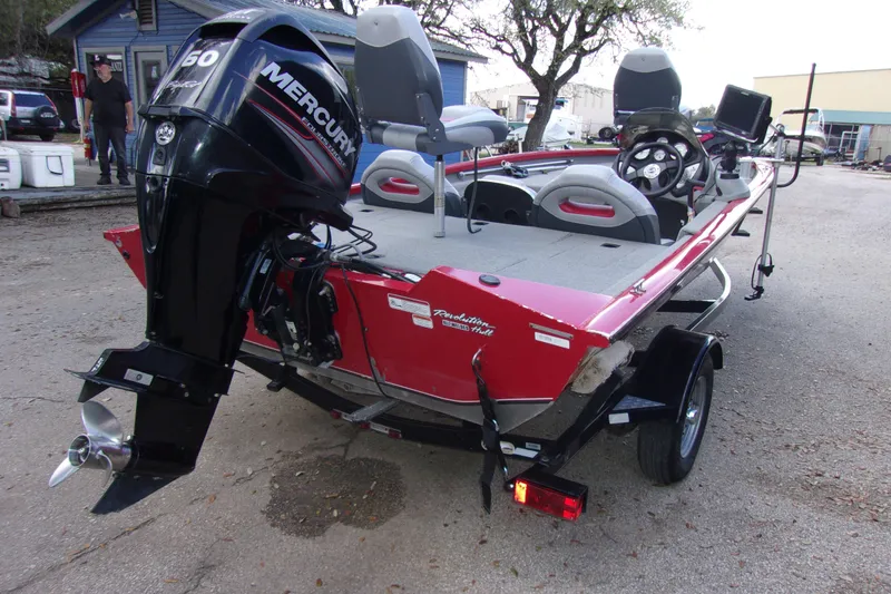 Slide: The Image of 2012 Tracker Pro Team 175 TXW boat with Mercury engine, parked outdoors. - 3