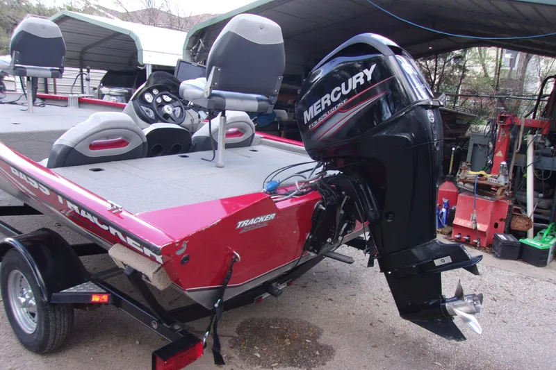 Slide: The Image of 2012 Tracker Pro Team 175 TXW boat with Mercury outboard motor, parked on trailer. - 4