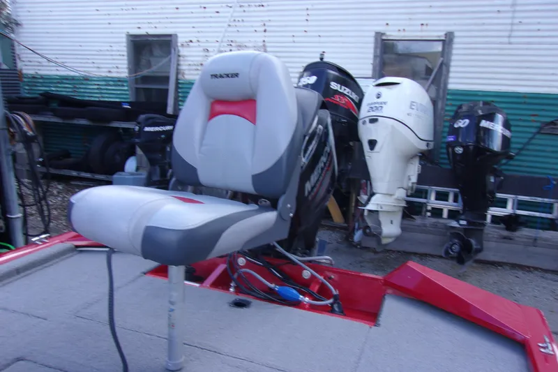 Slide: The Image of 2012 Tracker Pro Team 175 TXW boat seat with multiple outboard motors in the background. - 9