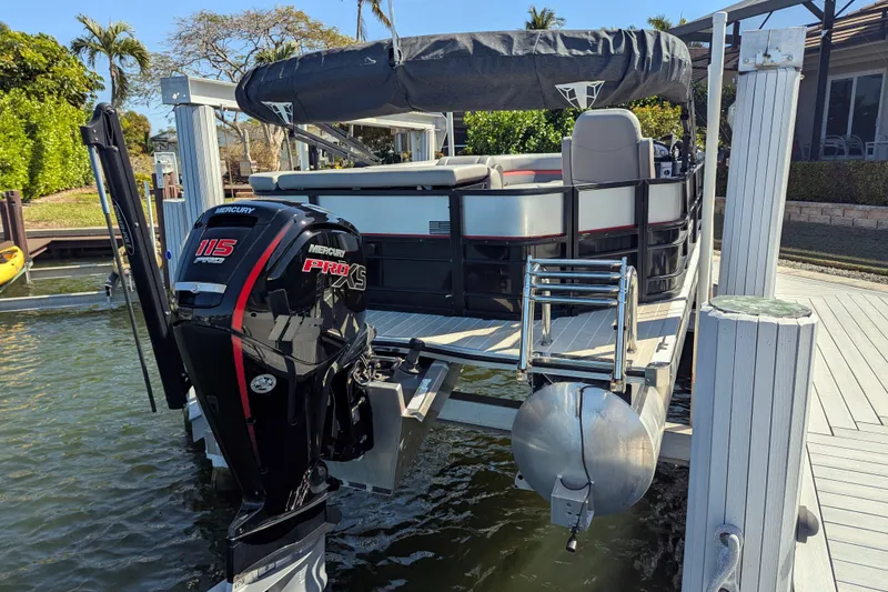 Slide: The Image of 2023 Trifecta 20CC 2.75 pontoon boat with Mercury 115 Pro XS engine on dock. - 12