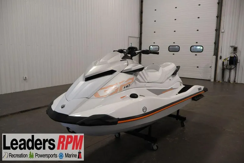 The Image of 2026 Yamaha WaveRunner GP HO in showroom, white with orange accents, displayed indoors. - 0