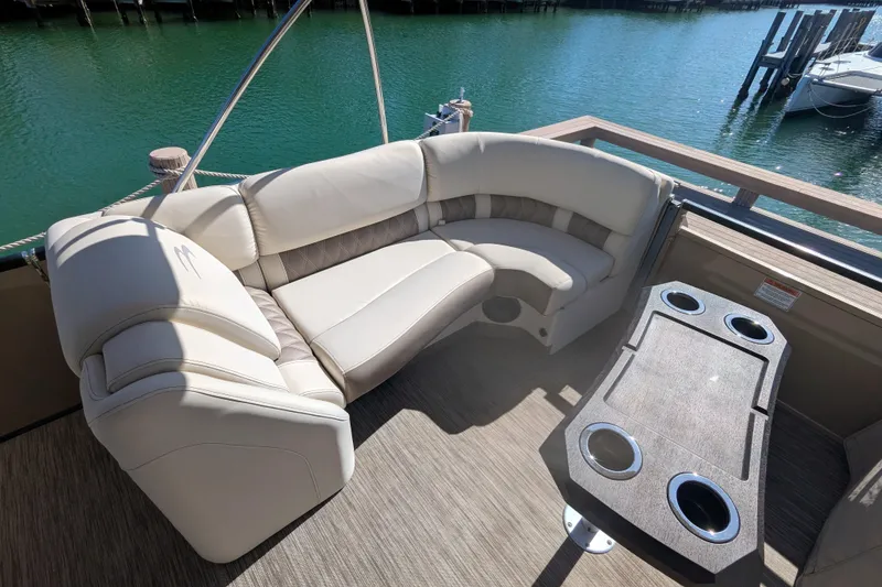 Slide: The Image of Luxurious seating on 2022 Bennington QXFBAX2 pontoon boat with scenic water view. - 10