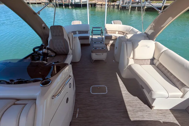Slide: The Image of Luxurious 2022 Bennington QXFBAX2 pontoon boat interior with plush seating and elegant design. - 12