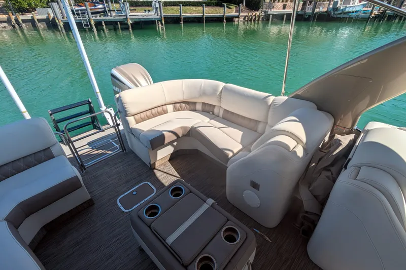 Slide: The Image of Luxurious 2022 Bennington QXFBAX2 pontoon boat interior with plush seating and cup holders. - 17