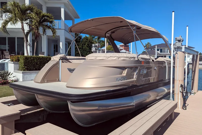 Slide: The Image of 2022 Bennington QXFBAX2 pontoon boat docked near waterfront home. - 20