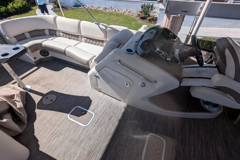 Slide: The Image of 2022 Bennington QXFBAX2 boat interior with plush seating and modern helm. - 8