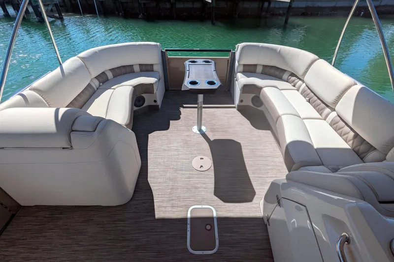 Slide: The Image of Luxurious 2022 Bennington QXFBAX2 pontoon boat interior with plush seating and table. - 9
