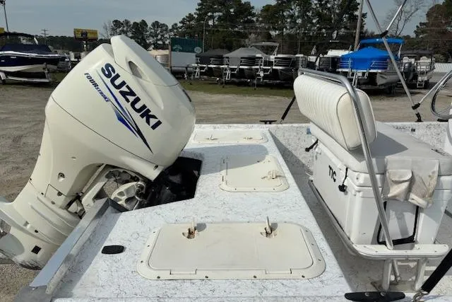 Slide: The Image of 2009 Kenner 19VX boat with Suzuki outboard motor, featuring storage compartments and seating. - 12