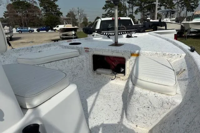 Slide: The Image of 2009 Kenner 19VX boat interior with white seating and open storage compartment. - 14