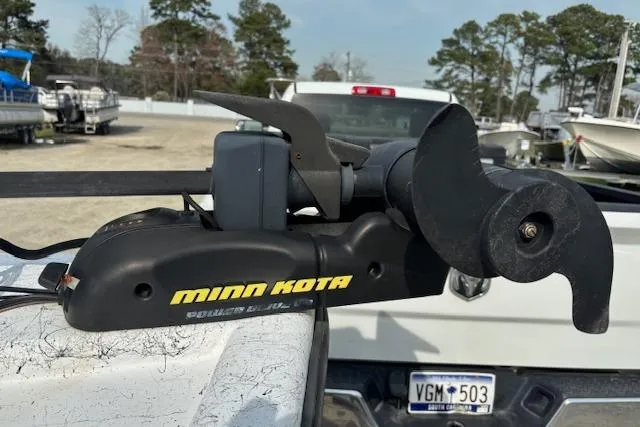 Slide: The Image of Minn Kota trolling motor on a 2009 Kenner 19VX boat, parked outdoors. - 17