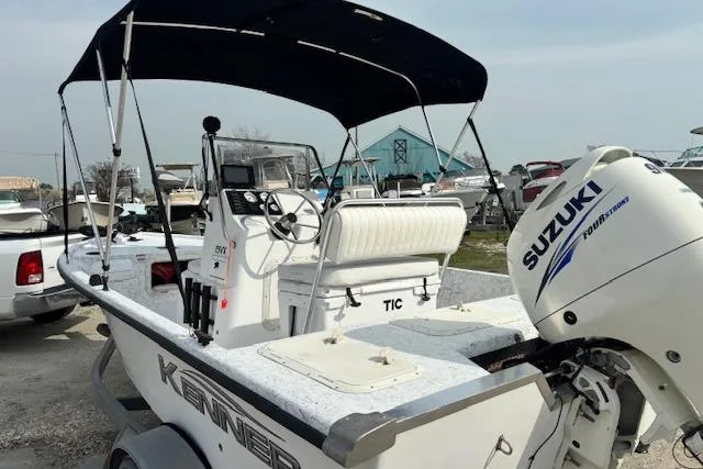 Slide: The Image of 2009 Kenner 19VX boat with Suzuki outboard motor, parked on a trailer. - 18