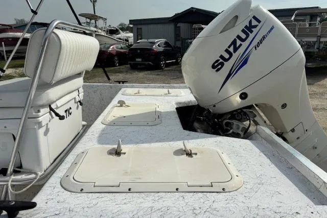 Slide: The Image of 2009 Kenner 19VX boat with Suzuki outboard motor, featuring seating and storage compartments. - 19