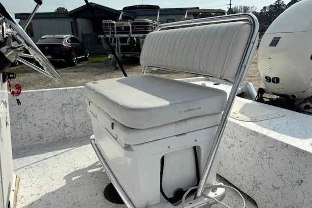 Slide: The Image of 2009 Kenner 19VX boat interior with cushioned seating and outboard motor. - 20