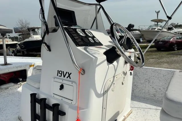Slide: The Image of 2009 Kenner 19VX boat console with steering wheel and control panel. - 21