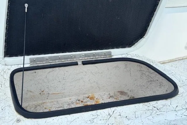 Slide: The Image of Open storage compartment on 2009 Kenner 19VX boat, showing interior details. - 24