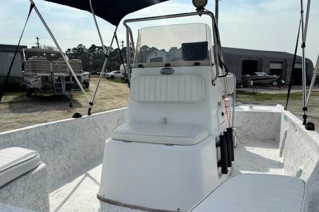 Slide: The Image of 2009 Kenner 19VX boat interior with seating and console, parked outdoors. - 26