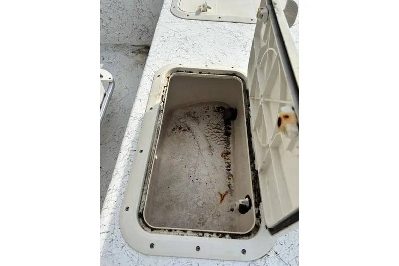Slide: The Image of Open storage compartment on a 2009 Kenner 19VX boat, showing interior details. - 28