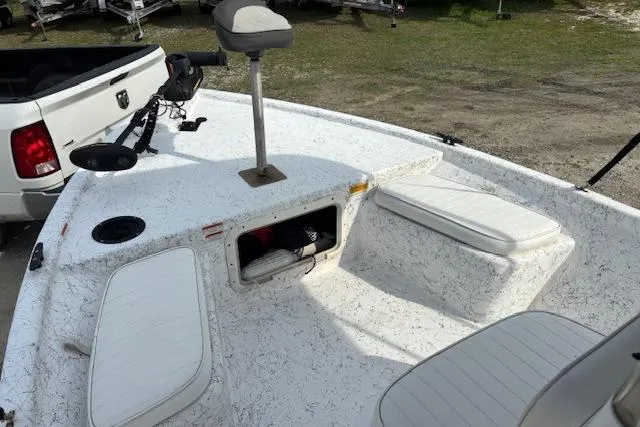 Slide: The Image of 2009 Kenner 19VX boat deck with seating and storage, parked near a white truck. - 31