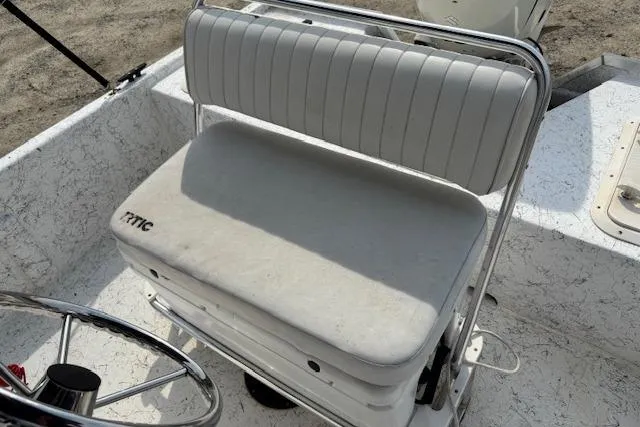 Slide: The Image of 2009 Kenner 19VX boat interior with white cushioned seating and steering wheel. - 32