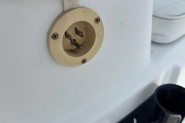 Slide: The Image of Close-up of a 2009 Kenner 19VX boat power outlet on a white surface. - 35