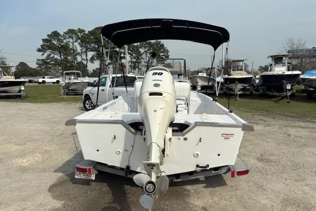 Slide: The Image of 2009 Kenner 19VX boat with outboard motor on trailer, parked outdoors. - 4