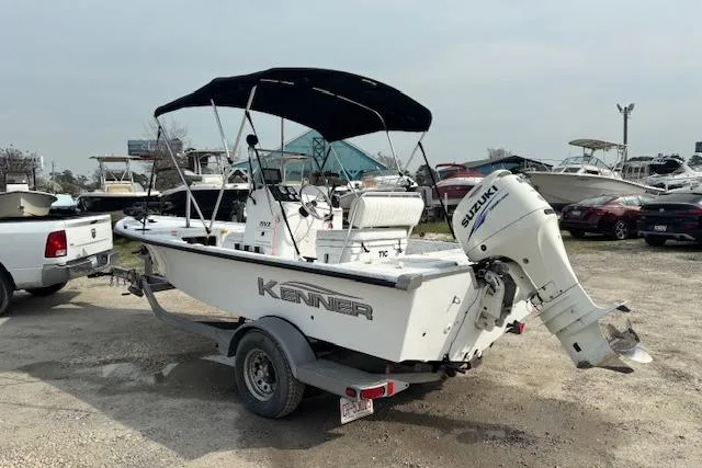 Slide: The Image of 2009 Kenner 19VX boat with Suzuki outboard motor on a trailer in a marina. - 5