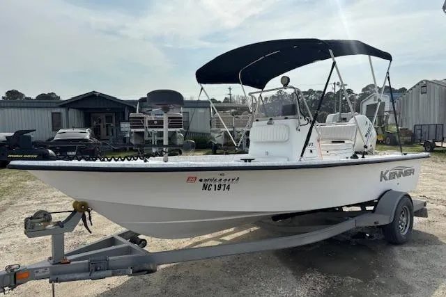 Slide: The Image of 2009 Kenner 19VX boat on trailer with canopy, parked outdoors. - 8