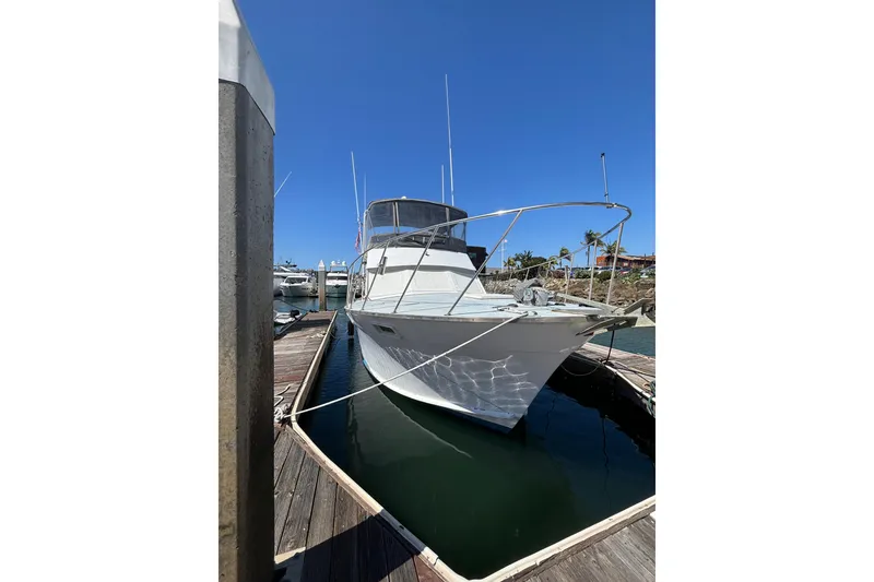 Slide: The Image of 1973 Luhrs 290 Sport Fisherman docked at marina under clear blue sky. - 3