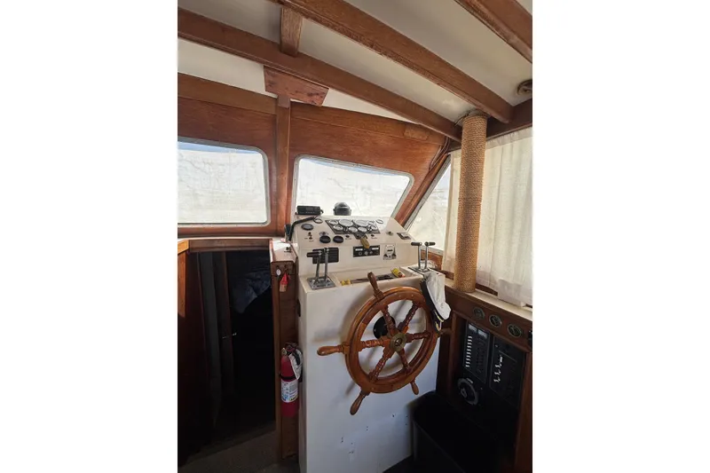 Slide: The Image of 1973 Luhrs 290 Sport Fisherman helm with wooden steering wheel and control panel. - 5