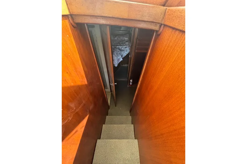 Slide: The Image of Stairway inside 1973 Luhrs 290 Sport Fisherman boat with wooden paneling. - 7