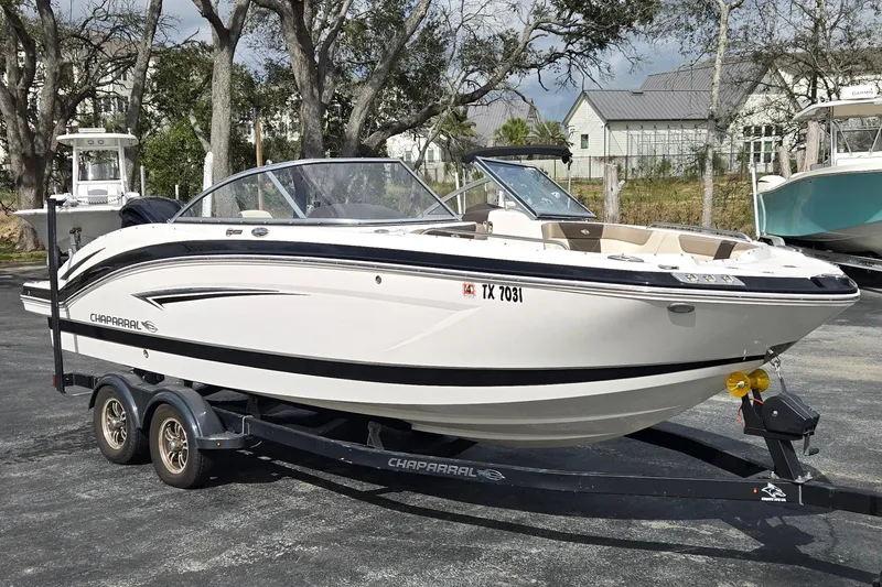 The Image of 2019 Chaparral 230 Suncoast boat on trailer, parked outdoors. - 1
