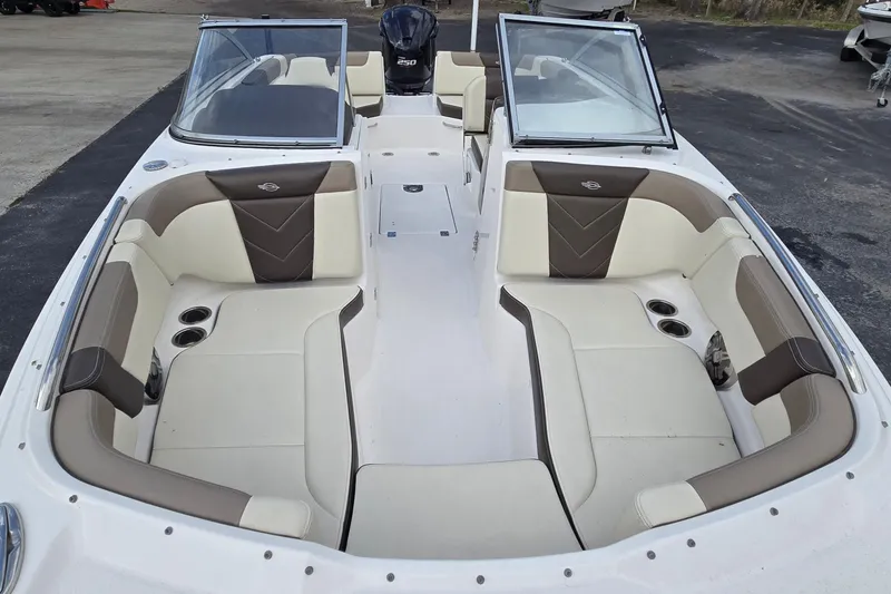 Slide: The Image of 2019 Chaparral 230 Suncoast boat interior with beige and brown seating. - 12