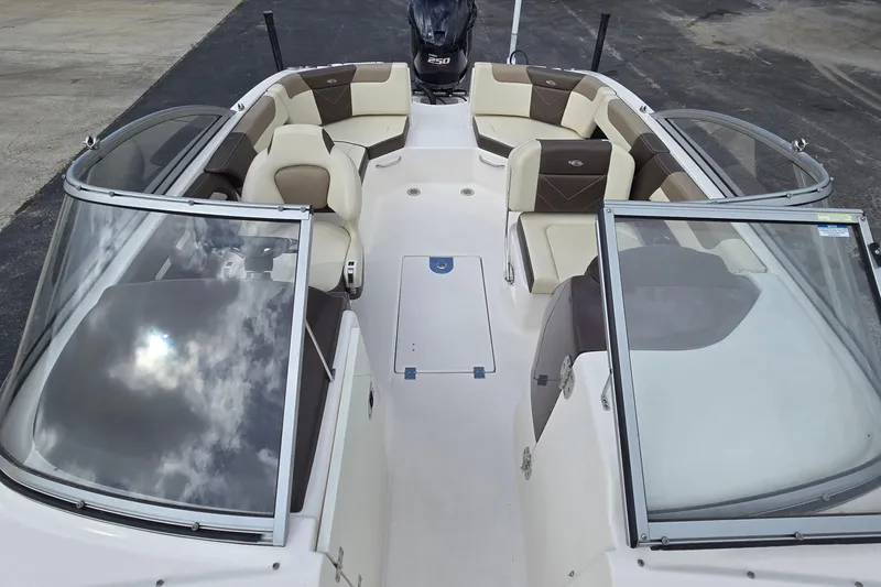 Slide: The Image of 2019 Chaparral 230 Suncoast boat interior with seating and windshield. - 13