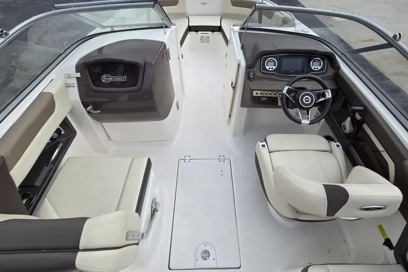 Slide: The Image of 2019 Chaparral 230 Suncoast boat interior with steering wheel and seating. - 17