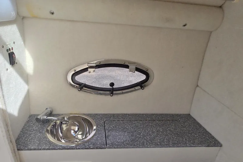 Slide: The Image of 2019 Chaparral 230 Suncoast interior with sink and oval window. - 19