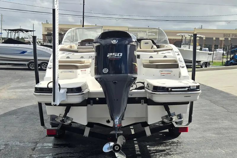 Slide: The Image of 2019 Chaparral 230 Suncoast boat with Yamaha 250 outboard motor, parked on a trailer. - 4