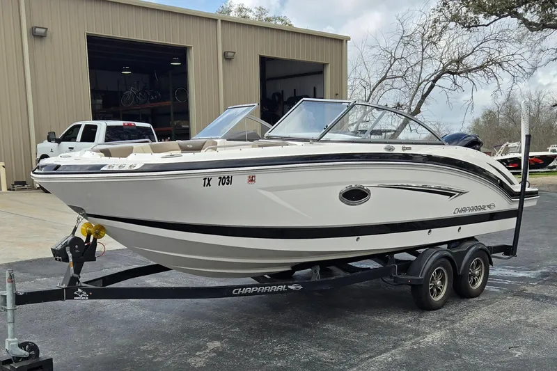 Slide: The Image of 2019 Chaparral 230 Suncoast boat on trailer outside a warehouse. - 7