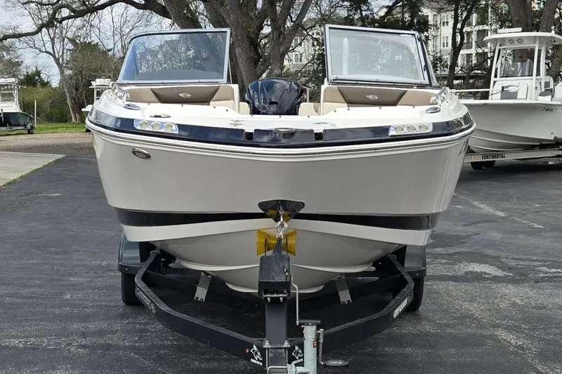 Slide: The Image of 2019 Chaparral 230 Suncoast boat on trailer, parked outdoors. - 8