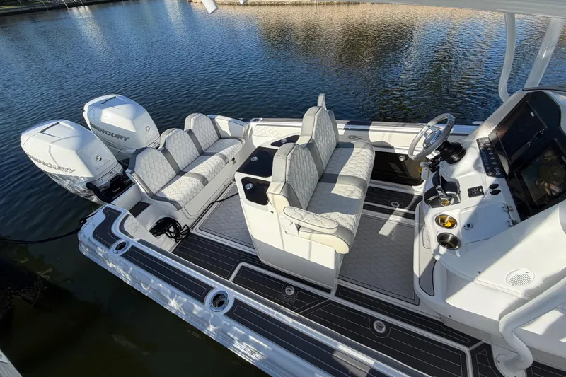 Slide: The Image of 2022 Glasstream 328 Pro-XS boat interior with dual Mercury engines, luxury seating, and modern controls. - 10