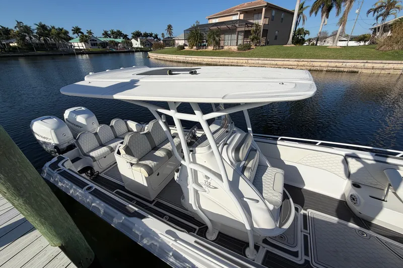 Slide: The Image of 2022 Glasstream 328 Pro-XS boat docked on a sunny waterfront. - 11