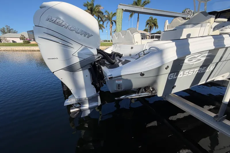 Slide: The Image of 2022 Glasstream 328 Pro-XS boat with Mercury Verado engine, docked by palm trees. - 12
